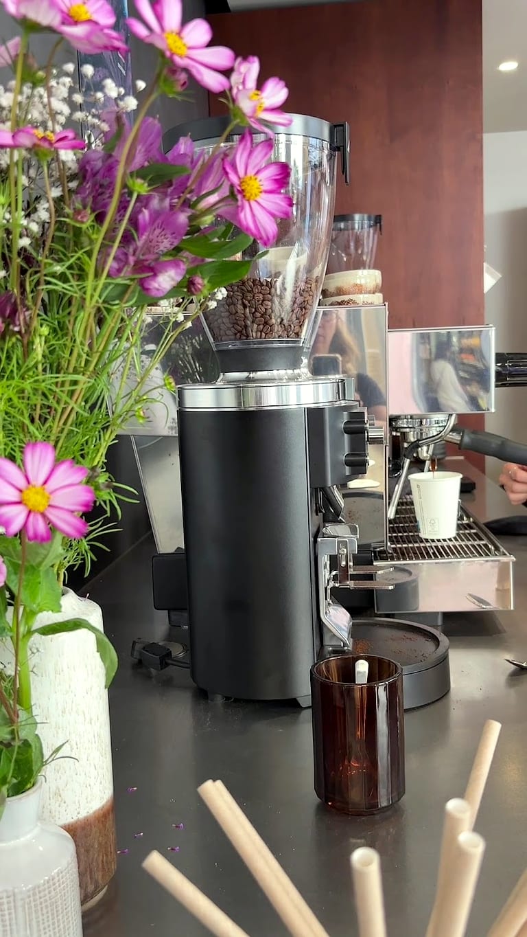 Le moulin à café et un bouquet de fleurs des champs au bout du comptoir.